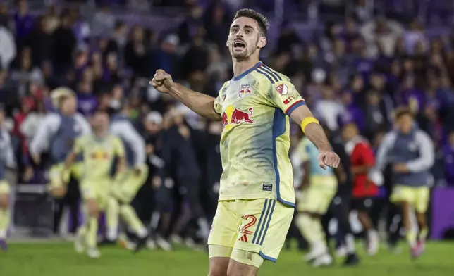 New York Red Bulls defender Dylan Nealis (12) react to the win against Orlando City in an MLS Eastern Conference final soccer match, Saturday, Nov. 30, 2024, in Orlando, Fla. (AP Photo/Kevin Kolczynski)