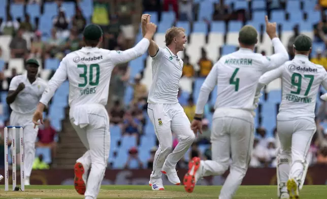 South Africa's Corbin Bosch, centre, celebrates with teammates after taking a wicket of Pakistan's Shan Masood for 17 runs during day one of the Test cricket match between South Africa and Pakistan, at the Centurion Park in Centurion, South Africa, Thursday, Dec. 26, 2024. (AP Photo/Themba Hadebe)