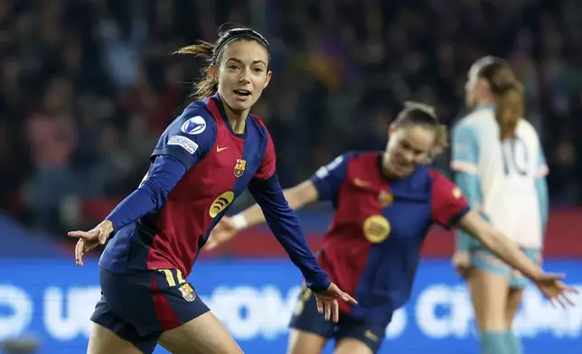 Barcelona's Aitana Bonmati, left, celebrates after scoring her side's second goal during the women's Champions League group D soccer match between FC Barcelona and Manchester City at the Olympic Stadium in Barcelona, Spain, Wednesday, Dec. 18, 2024. (AP Photo/Joan Monfort)