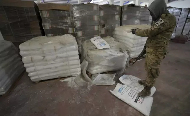 A Syrian member of the rebel group shows materials for manufacturing amphetamine pills known as Captagon, at the warehouse where the drug was manufactured before the fall of Bashar Assad government at a facility in Douma city, outskirts of Damascus, Syria, Friday, Dec. 13, 2024. (AP Photo/Hussein Malla)