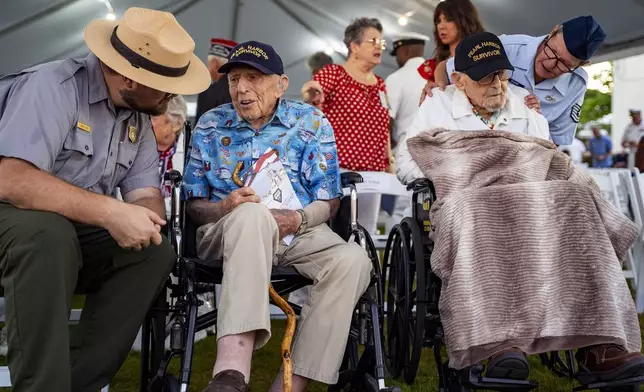 Pearl Harbor survivors, Ken Stevens, 102, of Powers, Ore., second from the left, and Ira "Ike" Schab, 104, of Beaverton, Ore., wait before the start of the 83rd Pearl Harbor Remembrance Day ceremony, Saturday, Dec. 7, 2024, in Honolulu. (AP Photo/Mengshin Lin)