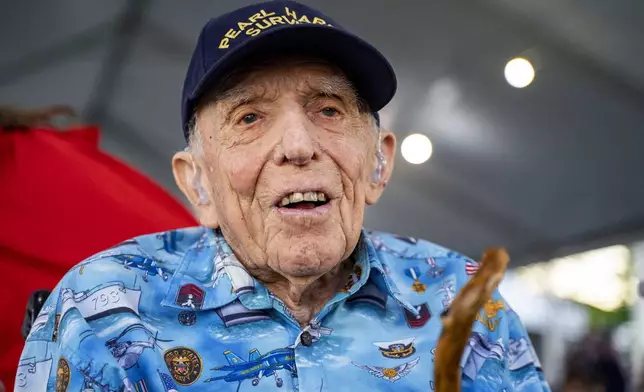 Ken Stevens, 102, of Powers, Ore., who survived the attack on Pearl Harbor talks to the media before the 83rd Pearl Harbor Remembrance Day ceremony, Saturday, Dec. 7, 2024, in Honolulu. (AP Photo/Mengshin Lin)