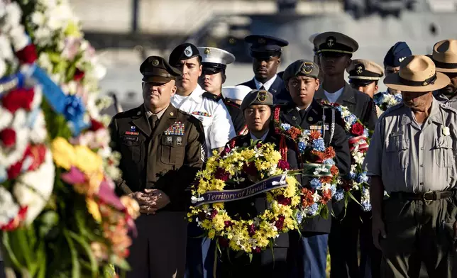 Servicemen and Park Service rangers present wreathes during the 83rd Pearl Harbor Remembrance Day ceremony, Saturday, Dec. 7, 2024, in Honolulu. (AP Photo/Mengshin Lin)