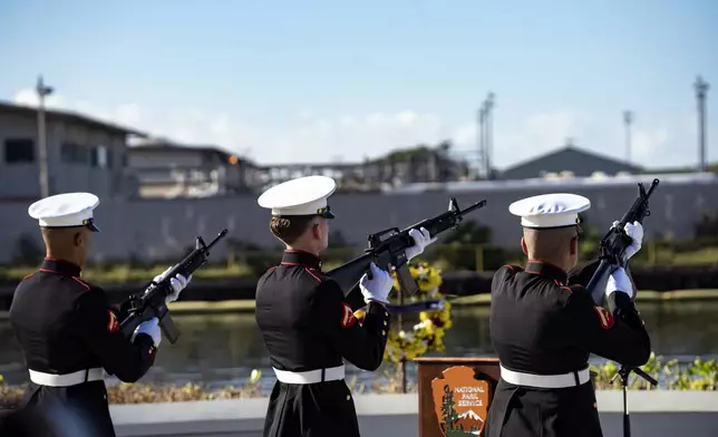 U.S. Marines perform a rifle salute before a Navy bugler plays taps during the 83rd Pearl Harbor Remembrance Day ceremony, Saturday, Dec. 7, 2024, in Honolulu. (AP Photo/Mengshin Lin)