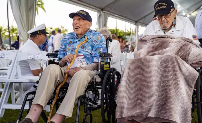 Pearl Harbor survivors, Ken Stevens, 102, of Powers, Ore., left, and Ira "Ike" Schab, 104, of Beaverton, Ore., wait for the start of the 83rd Pearl Harbor Remembrance Day ceremony, Saturday, Dec. 7, 2024, in Honolulu. (AP Photo/Mengshin Lin)