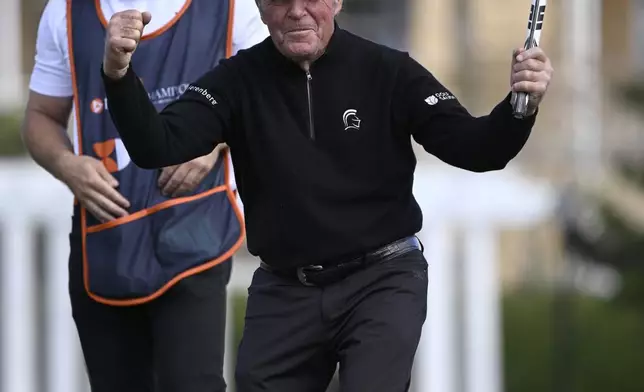 Gary Player, right, celebrates after making a putt on the 18th green as his son Wayne Player, left, looks on during the final round of the PNC Championship golf tournament, Sunday, Dec. 22, 2024, in Orlando, Fla. (AP Photo/Phelan M. Ebenhack)