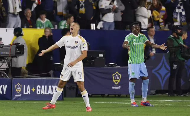 Los Angeles Galaxy forward Dejan Joveljic, left, celebrates after scoring during the second half of an MLS Western Conference final soccer match against the Seattle Sounders, Saturday, Nov. 30, 2024, in Carson, Calif. (AP Photo/Etienne Laurent)