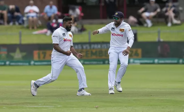 Sri Lanka's Lahiru Kumara, left, celebrates with teammate Sadeera Samarawickrama, after dismissing South Africa's Aiden Markam for 20 runs during the first day of the second test cricket match between South Africa and Sri Lanka, at St George's Park in Gqeberha, South Africa, Thursday, Dec. 5, 2024. (AP Photo/Themba Hadebe)