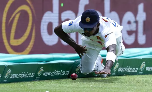 Sri Lanka's Vishwa Fernando dives but fails to prevent the boundary shot from South Africa's Ryan Rickelton during the first day of the second test cricket match between South Africa and Sri Lanka, at St George's Park in Gqeberha, South Africa, Thursday, Dec. 5, 2024. (AP Photo/Themba Hadebe)