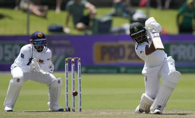 South Africa's captain Temba Bavuma, right, plays shot as Sri Lanka's Kusal Mendis watches on during the first day of the second Test cricket match between South Africa and Sri Lanka, at St George's Park in Gqeberha, South Africa, Thursday, Dec. 5, 2024. (AP Photo/Themba Hadebe)