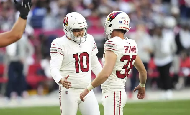 Arizona Cardinals kicker Chad Ryland (38) celebrates his field goal wit hpunter Michael Palardy (10) during the first half of an NFL football game against the New England Patriots, Sunday, Dec. 15, 2024, in Glendale, Ariz. (AP Photo/Ross D. Franklin)