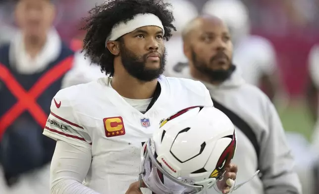 Arizona Cardinals quarterback Kyler Murray watches from the sidelines against the New England Patriots during the first half of an NFL football game, Sunday, Dec. 15, 2024, in Glendale, Ariz. (AP Photo/Ross D. Franklin)