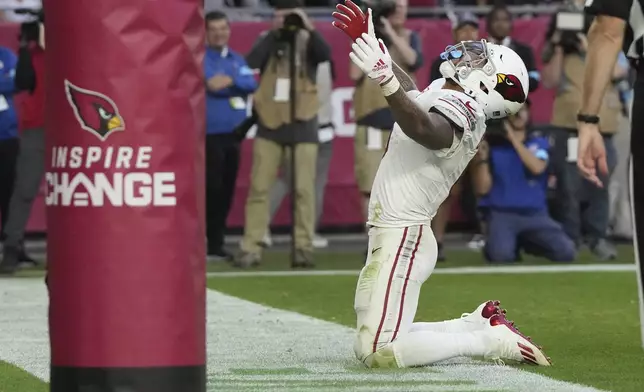 Arizona Cardinals running back James Conner celebrates his touchdown against the New England Patriots during the second half of an NFL football game, Sunday, Dec. 15, 2024, in Glendale, Ariz. (AP Photo/Rick Scuteri)