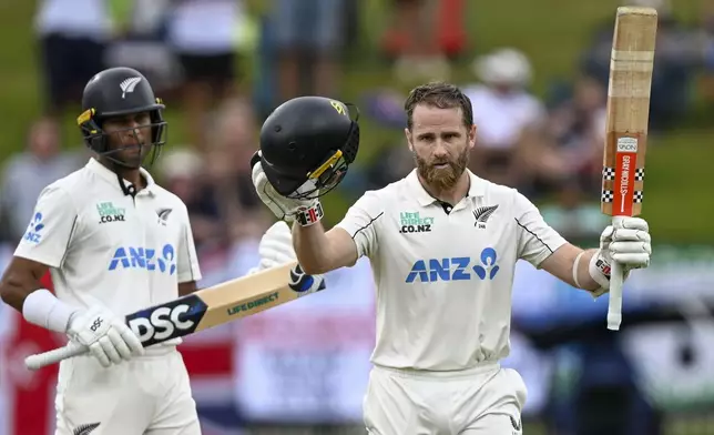 New Zealand's Kane Williamson celebrates after reaching a century during play on day three of the third cricket test between England and New Zealand in Hamilton, New Zealand, Monday, Dec. 16, 2024. (Andrew Cornaga/Photosport via AP)