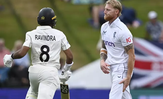 England captain Ben Stokes grabs at his leg while bowling during play on day three of the third cricket test between England and New Zealand in Hamilton, New Zealand, Monday, Dec. 16, 2024. (Andrew Cornaga/Photosport via AP)