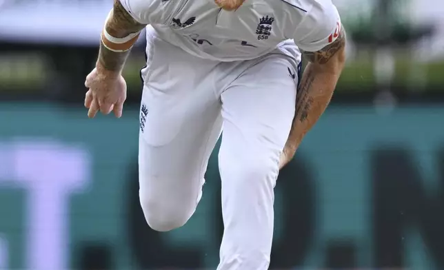 England captain Ben Stokes grabs at his leg while bowling during play on day three of the third cricket test between England and New Zealand in Hamilton, New Zealand, Monday, Dec. 16, 2024. (Andrew Cornaga/Photosport via AP)