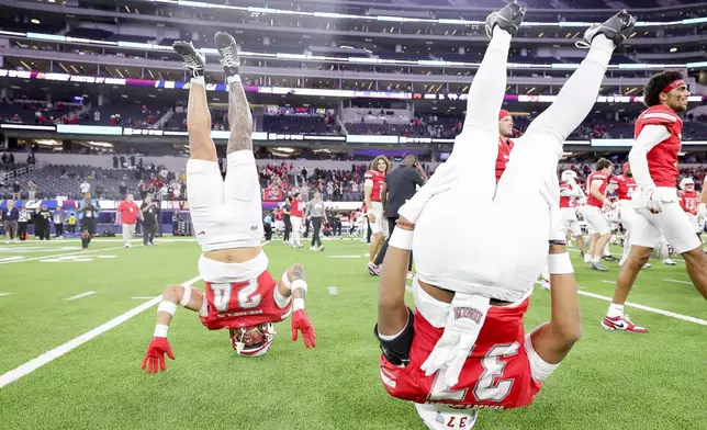 UNLV running back Darrien Jones, left, and defensive back Devin Hartsuck celebrate after the team's win against California during the LA Bowl NCAA college football game Wednesday, Dec. 18, 2024, in Inglewood, Calif. (AP Photo/Ryan Sun)