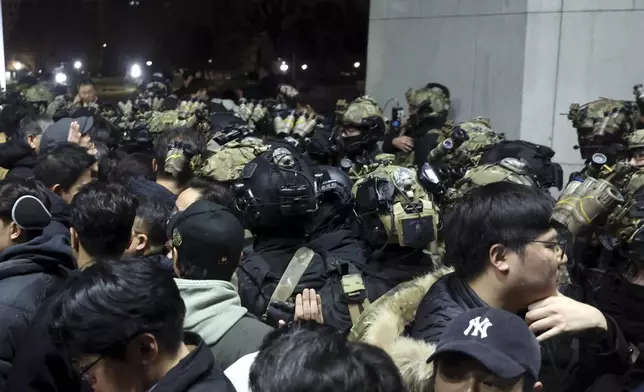 South Korean martial law soldiers try to enter the National Assembly compound in Seoul, South Korea, Wednesday, Dec. 4, 2024. (Cho Sung-bong/Newsis via AP)