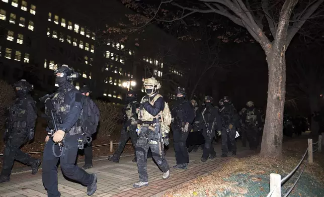 South Korean martial law soldiers leave the National Assembly in Seoul, South Korea, Wednesday, Dec. 4, 2024. (Kim Ju-sung/Yonhap via AP)