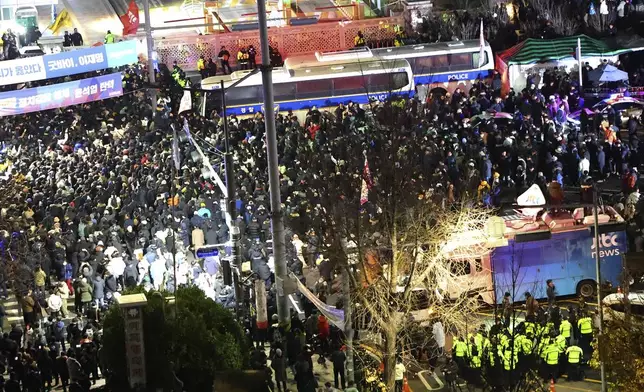 People gather to demand South Korean President Yoon Suk Yeol step down in front of the National Assembly in Seoul, South Korea, Wednesday, Dec. 4, 2024. (Kim Do-hoon/Yonhap via AP)