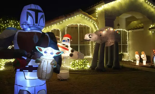 A Star Wars illuminated theme decorate the front lawn of a home in a neighborhood in Mesa, Ariz., Thursday, Dec. 12, 2024, in Mesa, Ariz. (AP Photo/Ross Franklin)