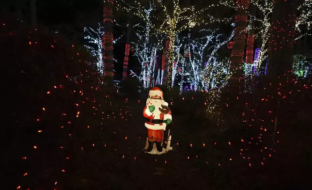 A Santa decoration is seen among holiday lights at the Lights of Joy display Monday, Dec. 16, 2024, in Kennesaw, Ga. (AP Photo/Brynn Anderson)