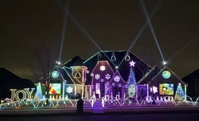 An elaborate holiday light display featuring music and imagery from the movie "Wicked" lights up the home of Elisabeth and Mark Miranda in Edmond, Okla.,, on Dec. 8, 2024. (Elisabeth Miranda via AP)