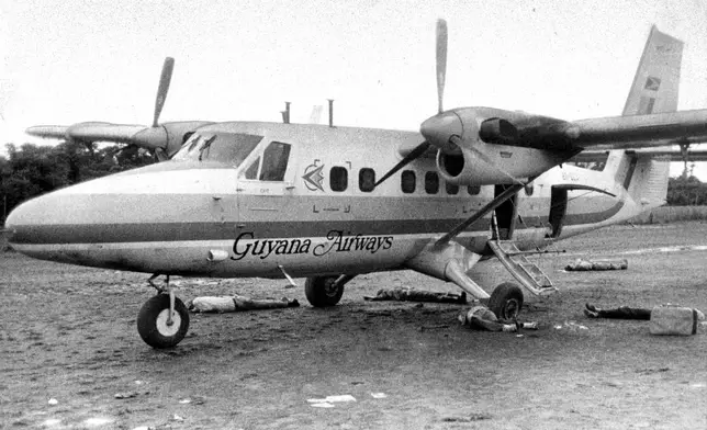 FILE - The bodies of five people, including Rep. Leo J. Ryan, D-Calif., lay on the airstrip at Port Kaittuma, Guyana, after an ambush by members of the Peoples Temple cult. (Tim Reiterman/The San Francisco Examiner via AP, File)