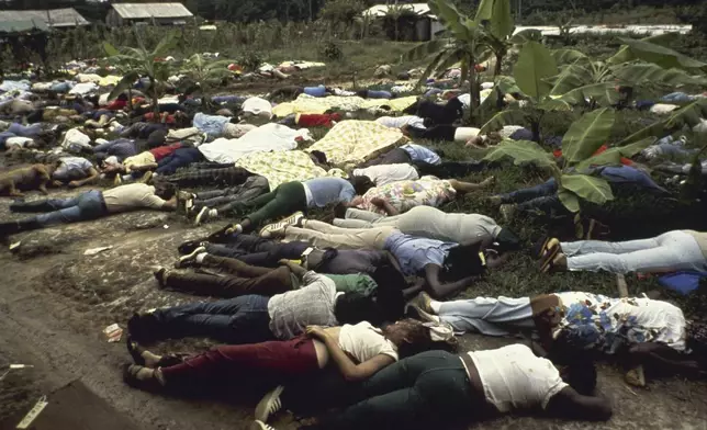 FILE - Followers of cult leader Jim Jones lay dead on the Peoples Temple compound where more than 900 members committed suicide, in Jonestown, Guayana, Nov. 1978. (AP Photo, File)