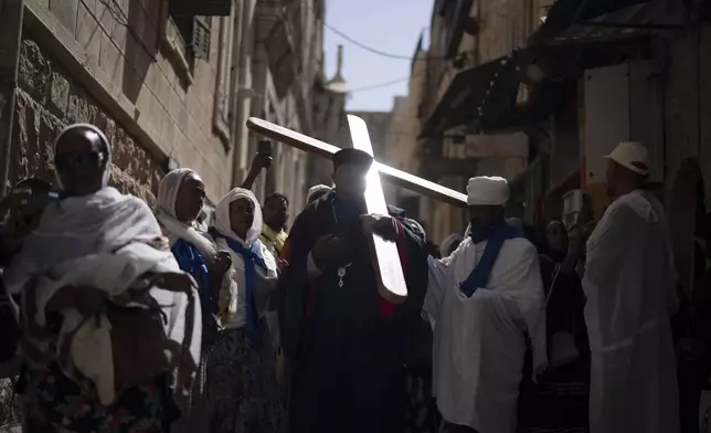 Ethiopian Orthodox Christian worshippers walk the Way of the Cross procession that commemorates Jesus Christ's crucifixion on Good Friday, in the Old City of Jerusalem, Friday, May 3, 2024. (AP Photo/Leo Correa)