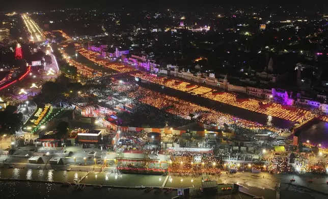 A record 2.51 million earthen oil lamps are lit along the Saryu river during Deepotsav celebrations on the eve of Diwali, creating a new Guinness World Record, in Ayodhya, India, Wednesday, Oct. 30, 2024. (AP Photo/Rajesh Kumar Singh)