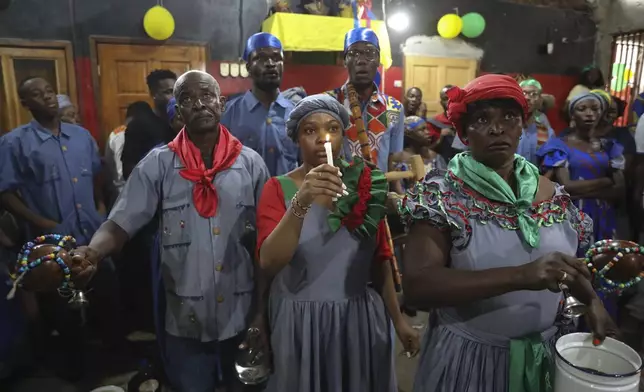 Vodou pilgrims attend a Mass marking the feast day of agriculture and work, in Port-au-Prince, Haiti, Wednesday, May 1, 2024. Amid the spiraling chaos, a growing number of Haitians are praying more or visiting Vodou priests known as "oungans" for urgent requests ranging from locating loved ones who were kidnapped to finding critical medication needed to keep someone alive. (AP Photo/Odelyn Joseph)