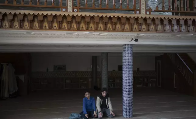 Students pray during recess in the mosque at Ibn Khaldoun, a private Muslim school, in Marseille, southern France, Tuesday, April 16, 2024. (AP Photo/Daniel Cole)