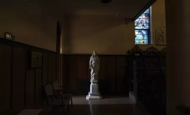 Light shines on a statue of Jesus in the chapel at the monastery of the Mount St. Scholastica Benedictine sisters in Atchison, Kan., Tuesday, July 16, 2024. (AP Photo/Jessie Wardarski)