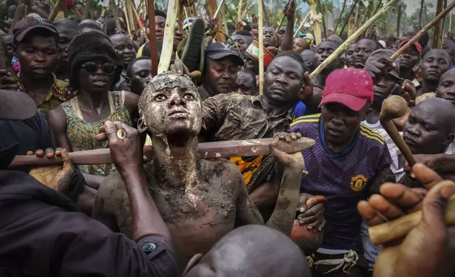 Daniel Wabuyi looks up during his traditional circumcision ritual, known as Imbalu, in Kamu village, Mbale, eastern Uganda, Saturday, Aug. 3, 2024. (AP Photo/Hajarah Nalwadda)