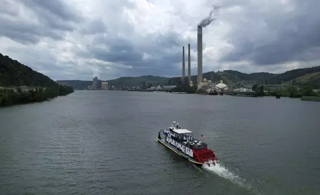 A riverboat carrying the Eucharist cruises down the Ohio River between Wellsburg, West Virginia, and Brilliant, Ohio, Sunday, June 23, 2024. The voyage is part of a two-month series of cross-country pilgrimages focused on the Eucharist, seeking to raise devotion around a sacrament in which Catholics believe they encounter Jesus' real presence. (AP Photo/Jessie Wardarski)