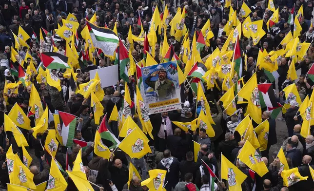 Palestinians hold yellow Fatah movement flags as they demonstrate in support of the Palestinian security forces in the Jenin refugee camp in the Israeli-occupied West Bank, Sunday, Dec. 29, 2024. (AP Photo/Majdi Mohammed)