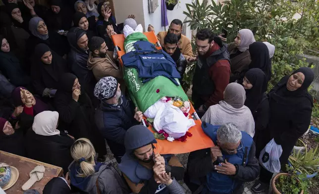 Relatives mourn as the body of Palestinian Shatha al-Sabbagh, a 22-year-old journalism student, is carried out of her family home during her funeral in the Jenin refugee camp in the Israeli-occupied West Bank, Sunday, Dec. 29, 2024. (AP Photo/Majdi Mohammed)