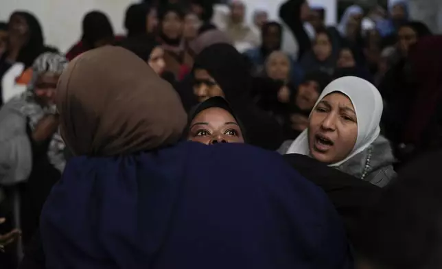 A mourner cries after taking a last look at the body of a relative, one of eight Palestinians killed, during their funeral following the withdrawal of the Israeli army, in the West Bank city of Tulkarem, Thursday, Dec. 26, 2024. (AP Photo/Matias Delacroix)