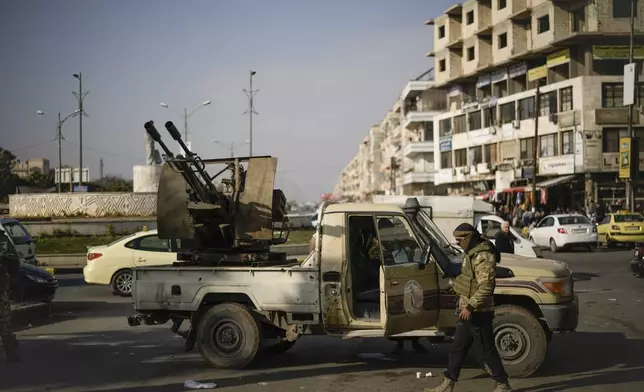 Security forces of the newly formed Syrian government patrol in downtown Homs, Syria, Thursday, Dec. 26, 2024. (AP Photo/Leo Correa)