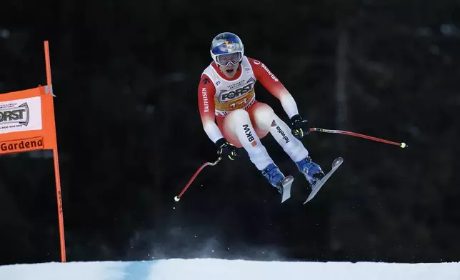 Switzerland's Marco Odermatt speeds down the course during an alpine ski, men's World Cup downhill, in Val Gardena, Italy, Saturday, Dec. 21, 2024. (AP Photo/Gabriele Facciotti)