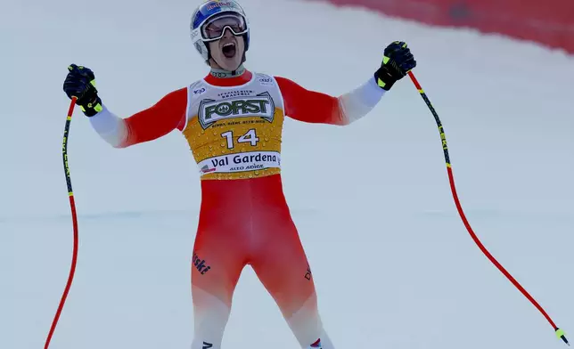 Switzerland's Marco Odermatt celebratesat the finish area of an alpine ski, men's World Cup downhill, in Val Gardena, Italy, Saturday, Dec. 21, 2024. (AP Photo/Alessandro Trovati)