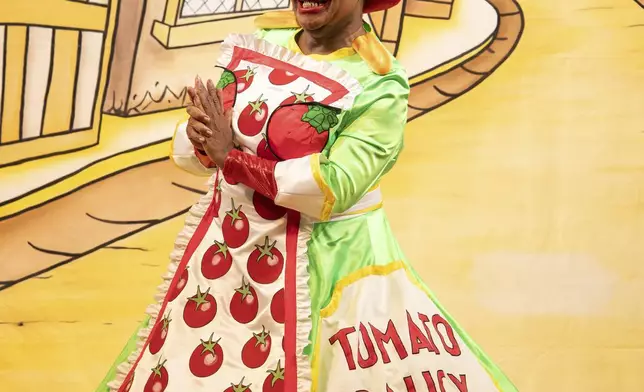 Clive Rowe as Dame Sarah the Cook poses on stage during a photocall for Hackney Empire's 25th pantomime, Dick Whittington and His Cat, in London, Tuesday, Dec. 3, 2024. (AP Photo/Thomas Krych)