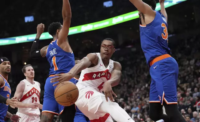 Toronto Raptors forward Scottie Barnes (4) moves the ball past New York Knicks guard Cameron Payne (1) during the first half of an NBA basketball game in Toronto, Monday, Dec. 9, 2024. (Nathan Denette//The Canadian Press via AP)