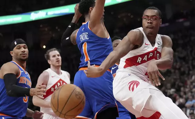 Toronto Raptors forward Scottie Barnes (4) moves the ball past New York Knicks guard Cameron Payne (1) during the first half of an NBA basketball game in Toronto, Monday, Dec. 9, 2024. (Nathan Denette//The Canadian Press via AP)