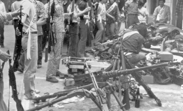 FILE- Korean student demonstrators gather with their collection of weapons, stolen from police and military, at a government building, in Gwangju (Kwangju), South Korea, May 24, 1980, during anti-government demonstrations. (AP Photo/File)