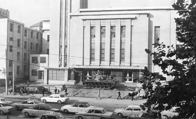 FILE- An army tank stands guard in front of the National Assembly building in the heart of this South Korean capital of Seoul on Oct. 18, 1972. The single-house parliament was closed by Martial Law proclaimed. (AP Photo/File)