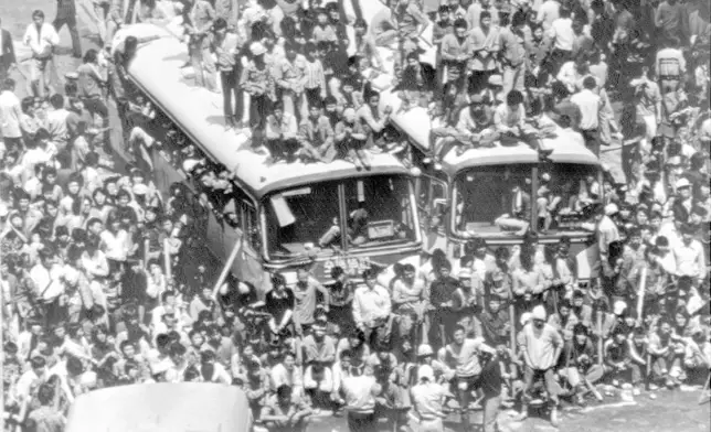 FILE- Commandeered city buses are used to block a main downtown street of Gwangju (Kwangju), May 23, 1980 by demonstrators against riot police and paratroopers during riotous anti-government protests this week. (AP Photo/File)