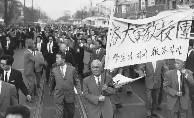 FILE- Some 200 college professors representing 27 colleges, march along a Seoul street, in South Korea, on April 25, 1960, after a meeting at the Seoul University. The professors expressed embarrassment that they had left it to their students to lead the movement against what they considered misrule by President Sungman Rhee. (AP Photo/File)