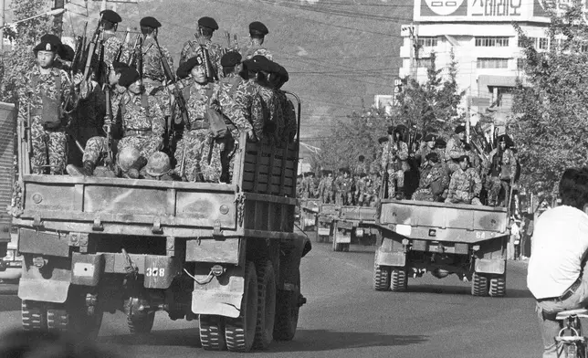FILE- Truckloads of South Korean paratroopers move in downtown Masan on Oct. 20, 1979 as a "garrison decree" was proclaimed following two days of rioting against the government in this south coast city, 300 km south of Seoul, South Korea. (AP Photo/Kim Chon-Kil, File)